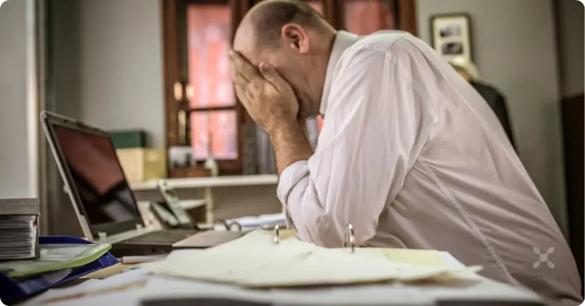 An employee tired from implementing their ERP while still doing their full-time job
