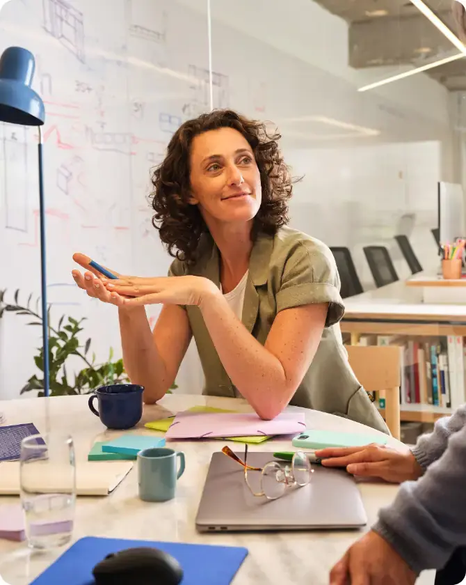 Smiling woman leading a discussion in a team meeting Smiling woman leading a discussion in a team meeting
